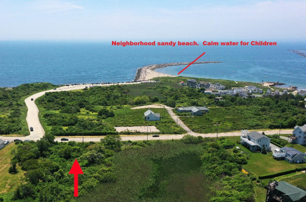 West view to neighborhood beach and breakwater